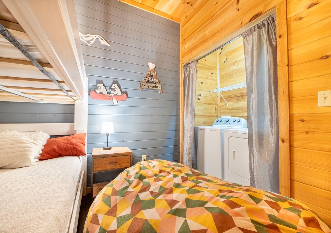 Bunk room with wood cabin walls at Smoky Summit Stays