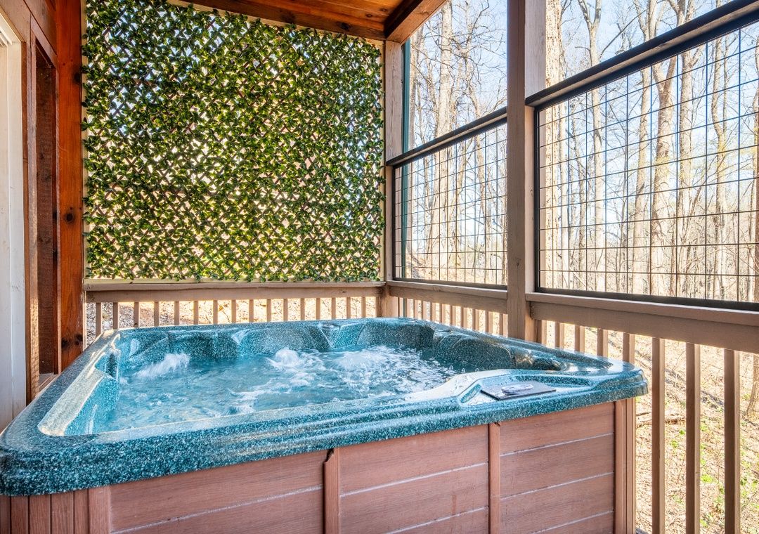 Hot tub on the covered deck at Smoky Summit Stays