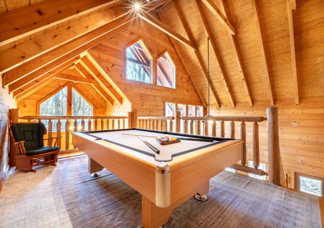 Pool table in the loft game area at Smoky Summit Stays