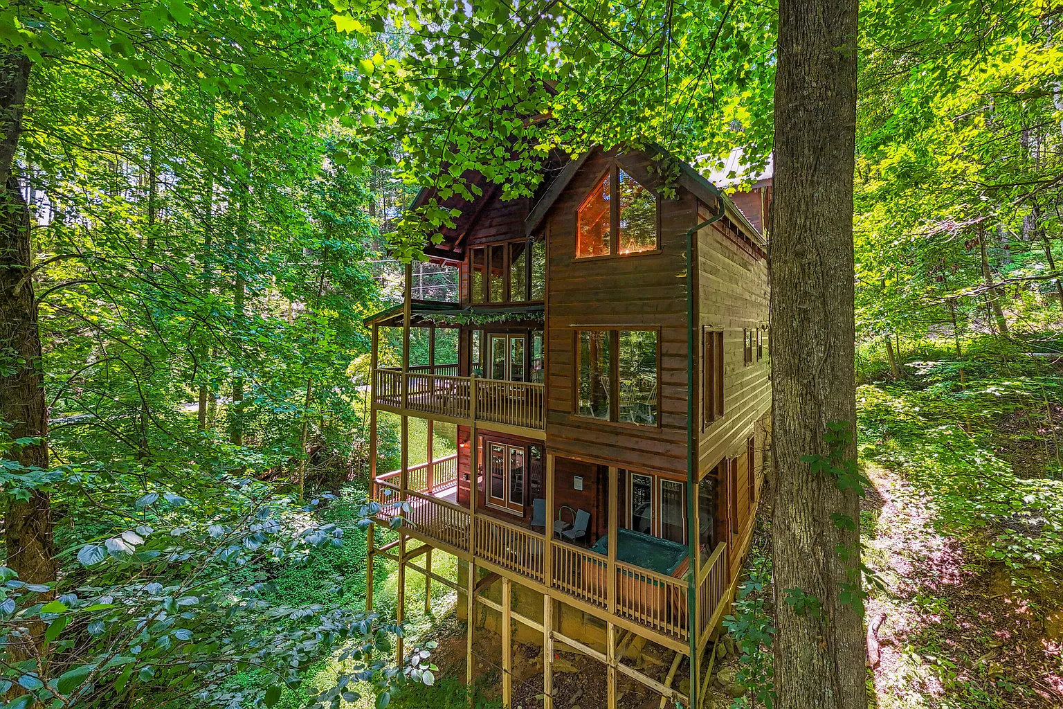 Smoky Summit Stays cabin exterior surrounded by green wooded scenery in Sevierville, Tennessee